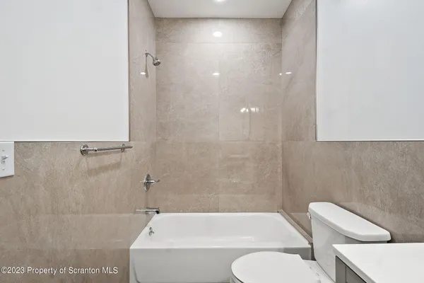a bathroom with a toilet and a bathtub