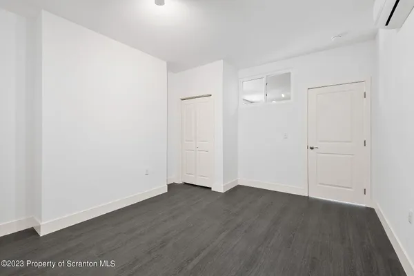 an empty room with wooden floor