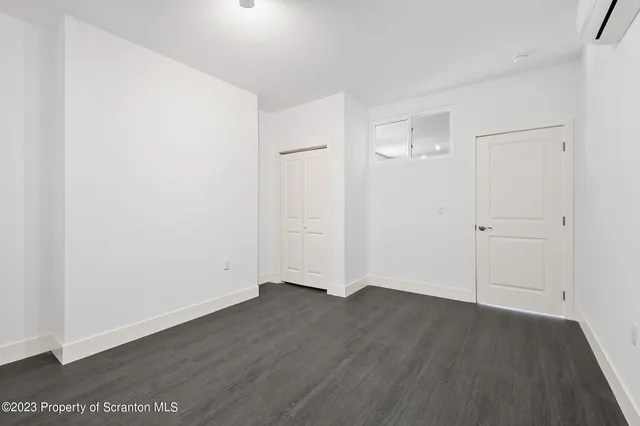 an empty room with wooden floor