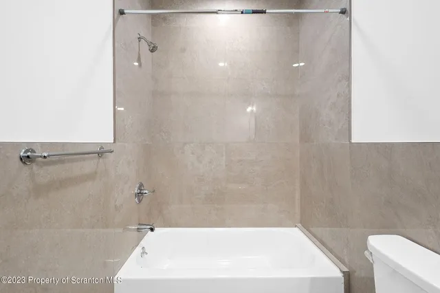 a bathroom with a white bath tub