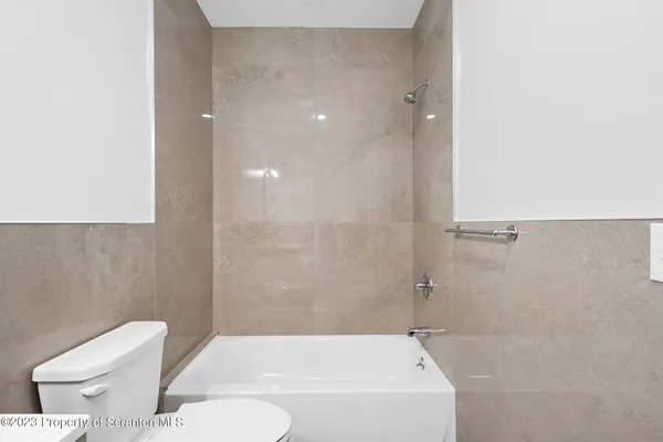 a bathroom with a bathtub and a toilet