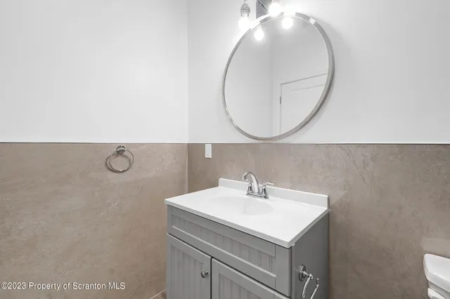 a bathroom with a sink mirror and vanity