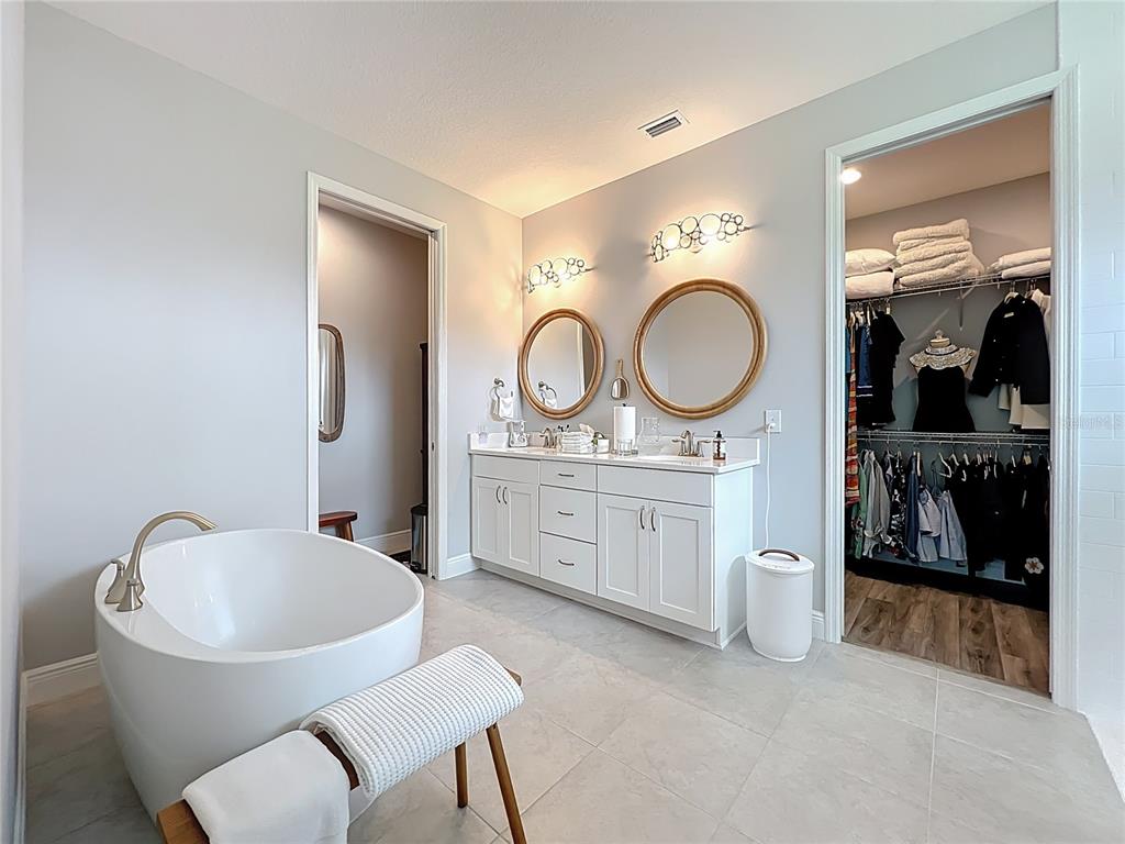 10220 Bay Lake Road Groveland, FL 34736 - Photo 30 of 90 a bathroom with a toilet a sink and a mirror