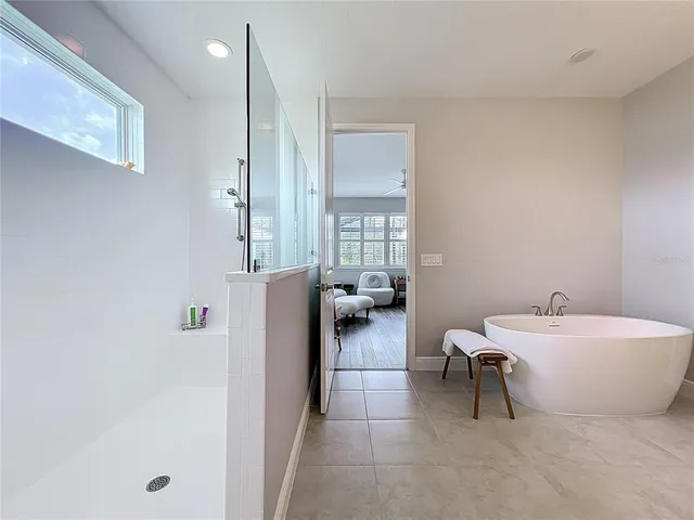 a view of pool with a table and chairs