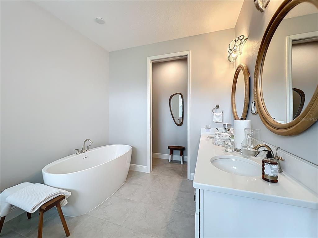 10220 Bay Lake Road Groveland, FL 34736 - Photo 33 of 90 a bathroom with a sink mirror and toilet