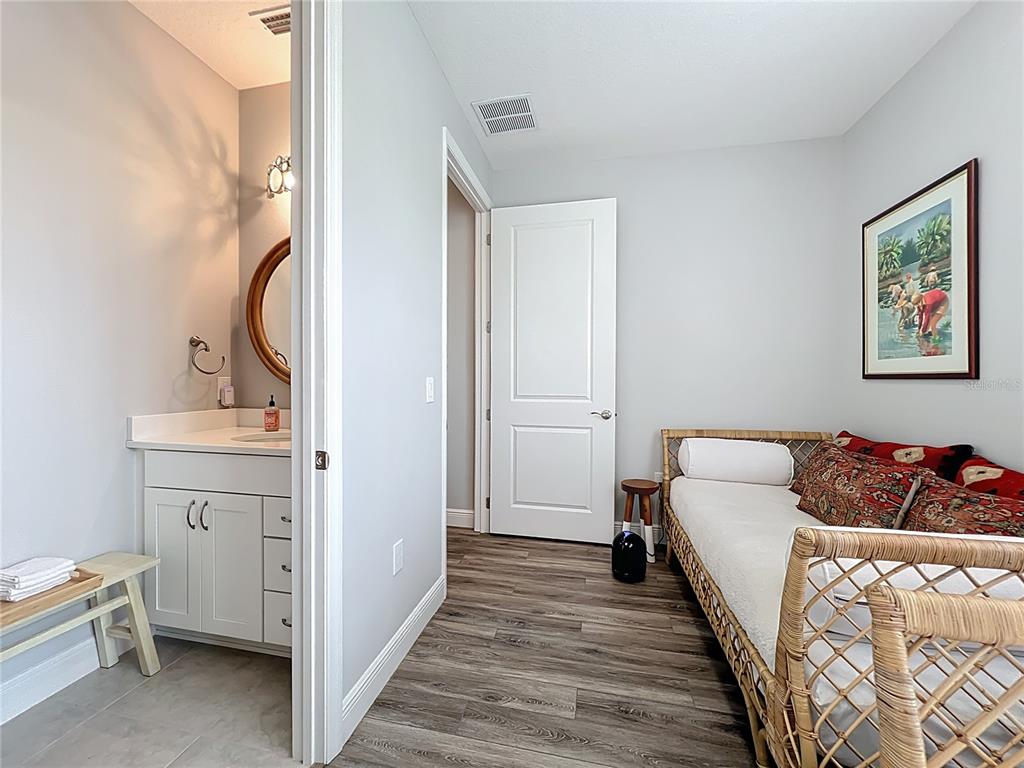 10220 Bay Lake Road Groveland, FL 34736 - Photo 43 of 90 a bed room with a bed and a mirror