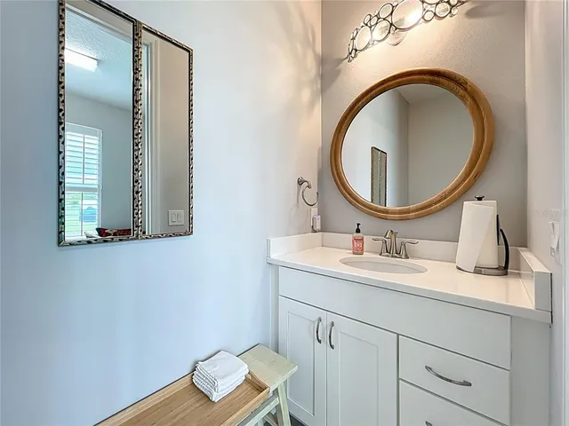 a bathroom with a sink toilet and vanity