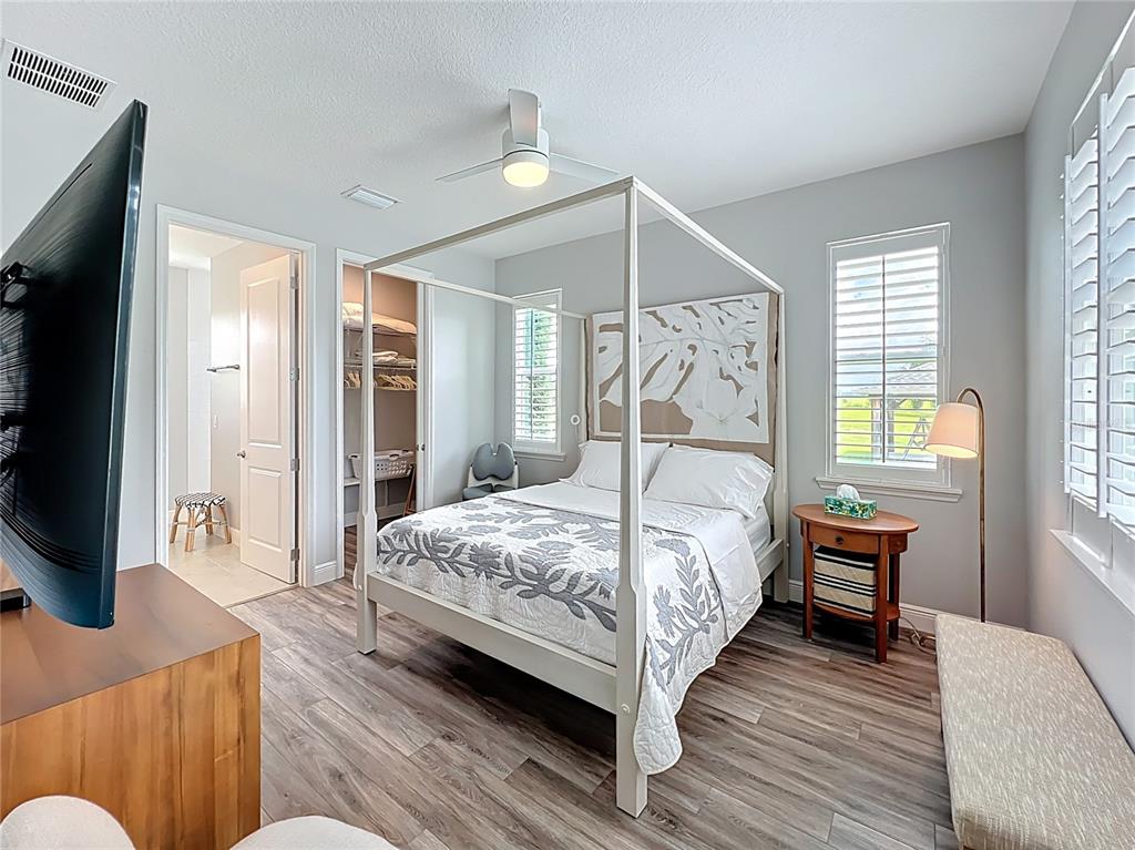 10220 Bay Lake Road Groveland, FL 34736 - Photo 69 of 90 a bedroom with a bed and a flat screen tv