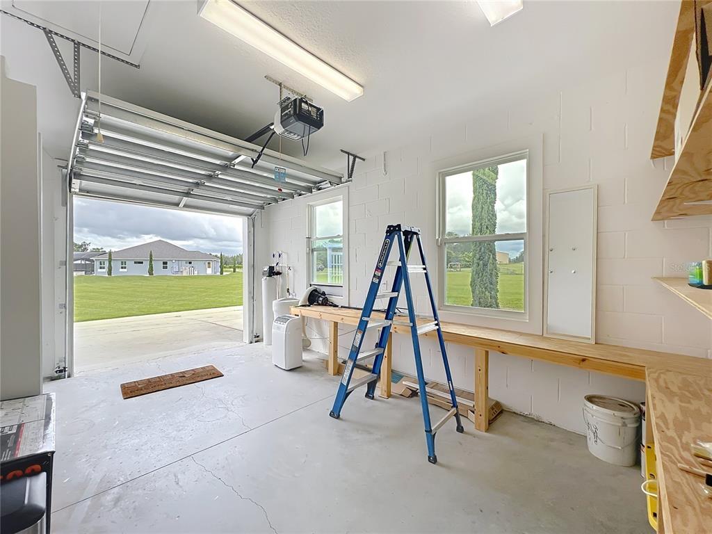 10220 Bay Lake Road Groveland, FL 34736 - Photo 76 of 90 a view of a hall with a dining table and chairs