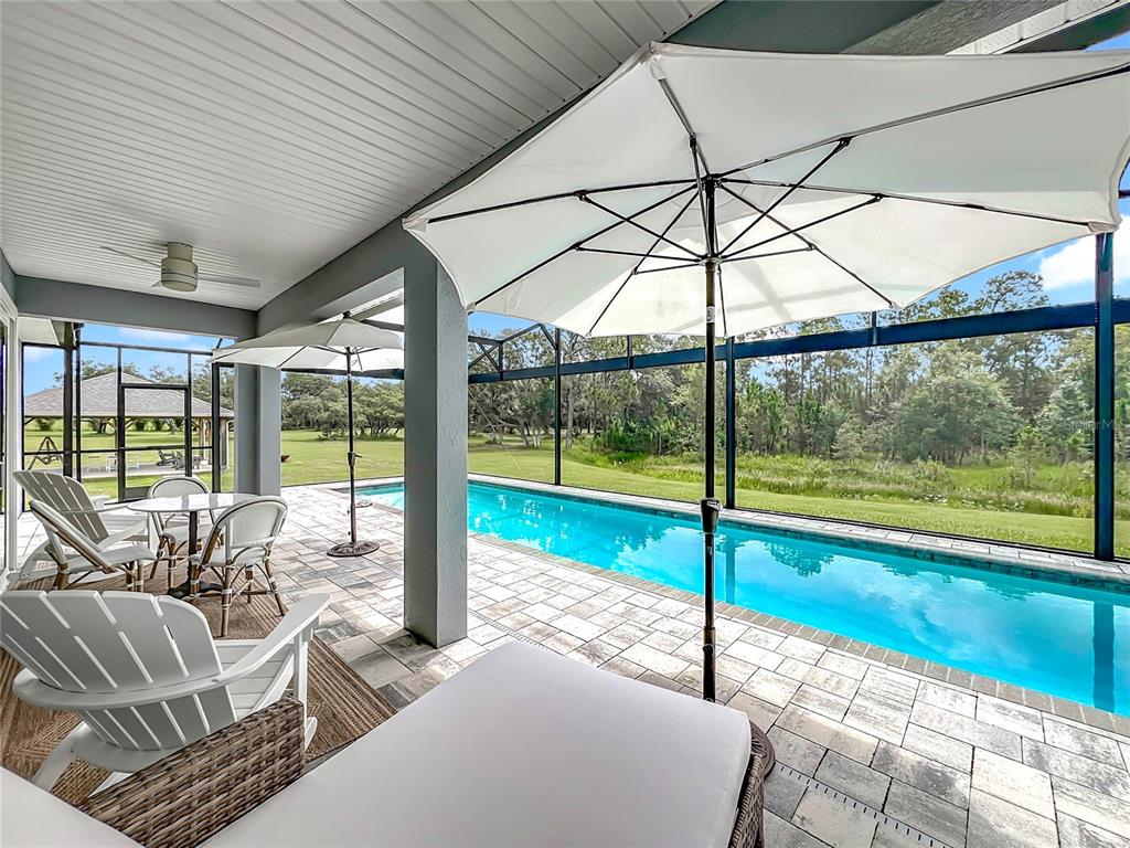 10220 Bay Lake Road Groveland, FL 34736 - Photo 77 of 90 a living room with a floor to ceiling window and floor to ceiling window