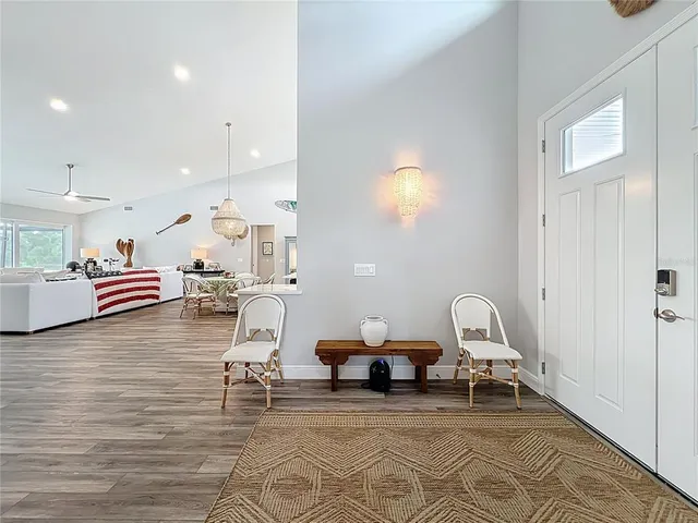 a living room with dining room and wooden floor