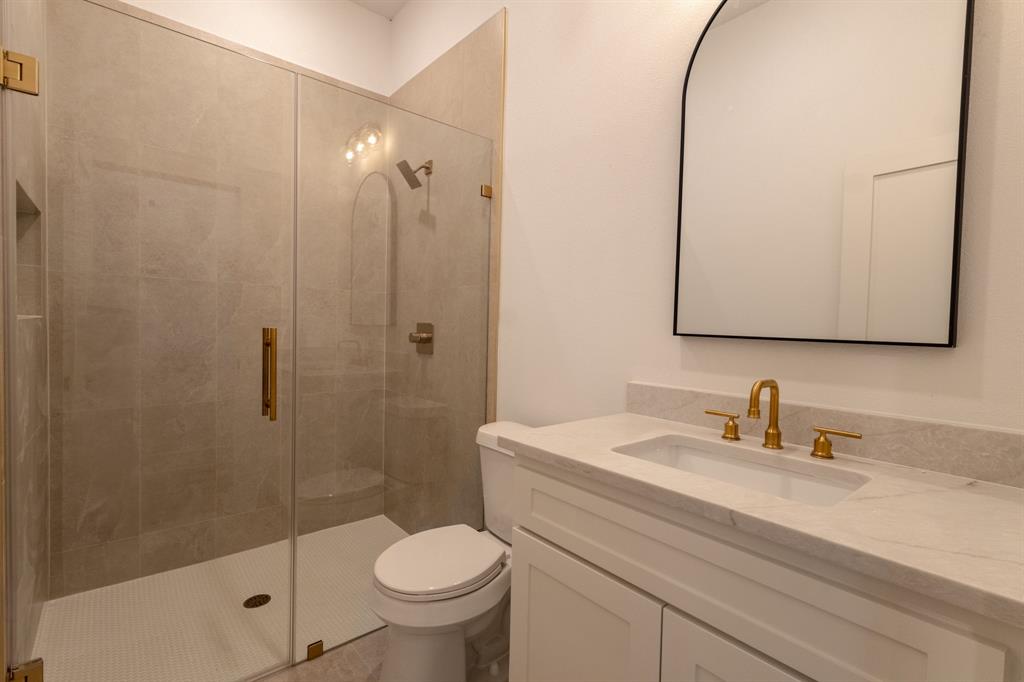 2900 8th Avenue Fort Worth, TX 76110 - Photo 22 of 32 a bathroom with a sink a toilet and shower