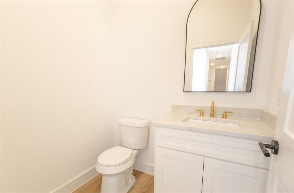 2900 8th Avenue Fort Worth, TX 76110 - Photo 24 of 32 a bathroom with a toilet sink and mirror