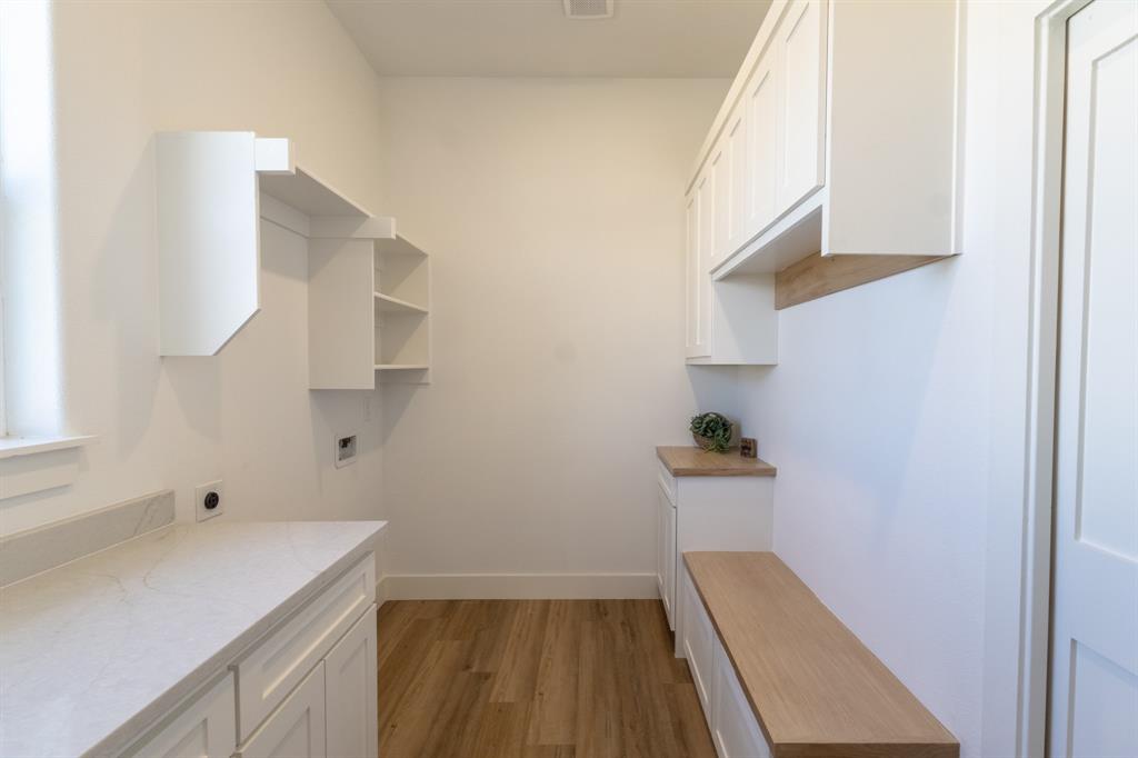 2900 8th Avenue Fort Worth, TX 76110 - Photo 25 of 32 a storage room with wooden floor washer and dryer