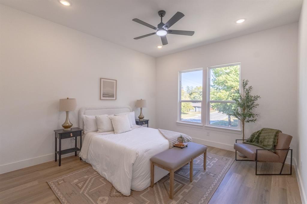 2900 8th Avenue Fort Worth, TX 76110 - Photo 10 of 32 a bed room with a bed and a chair