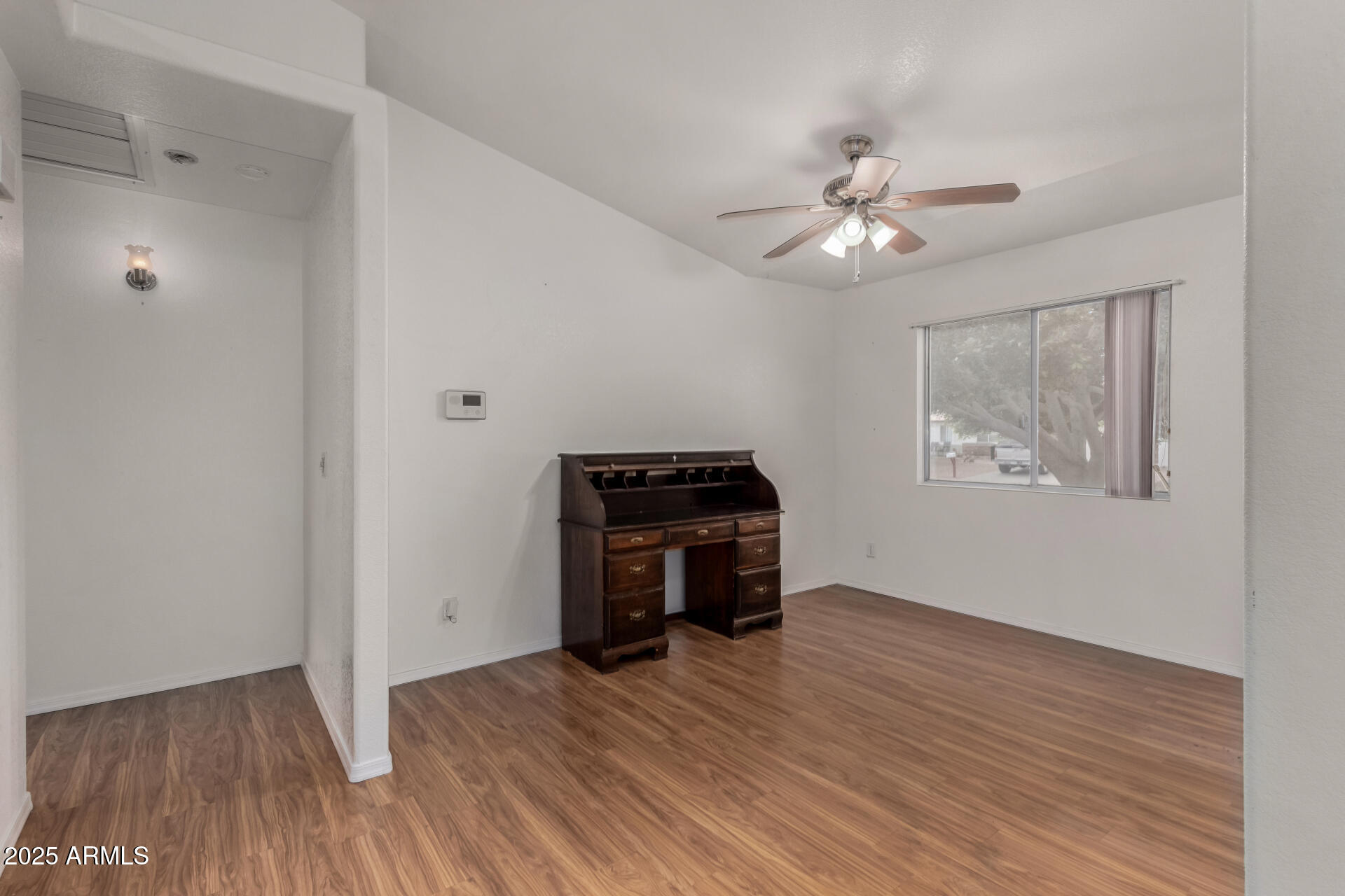 1794 West 11th Avenue Apache Junction, AZ 85120 - Photo 12 of 33 a view of empty room with wooden floor and fan