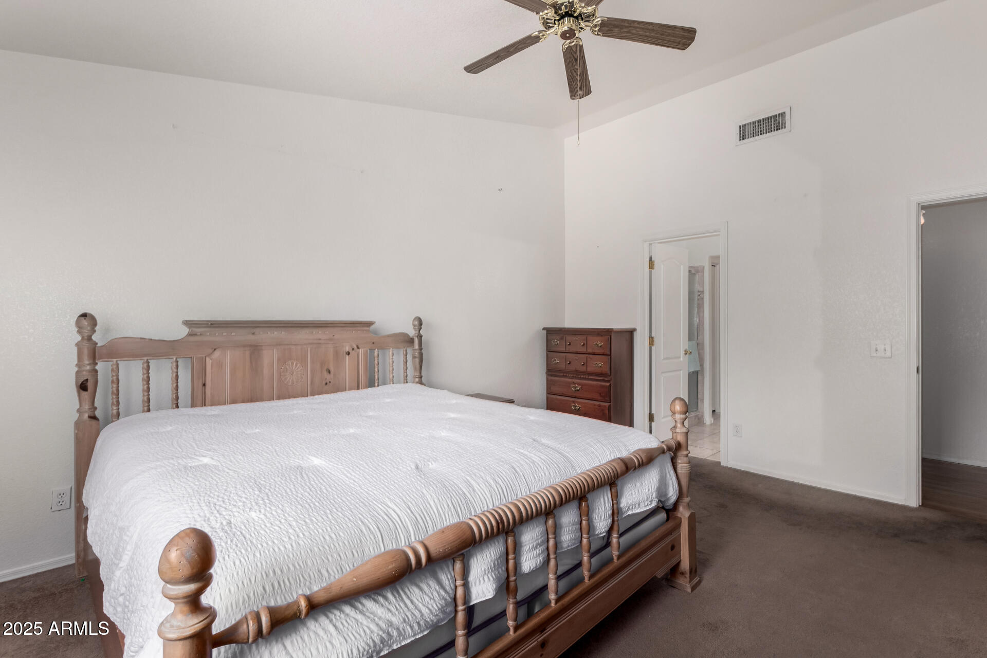 1794 West 11th Avenue Apache Junction, AZ 85120 - Photo 17 of 33 a bedroom with a bed and a chandelier