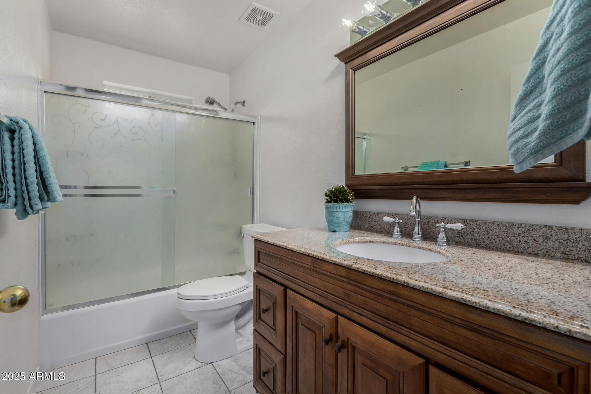 1794 West 11th Avenue Apache Junction, AZ 85120 - Photo 23 of 33 a bathroom with a granite countertop sink toilet and shower