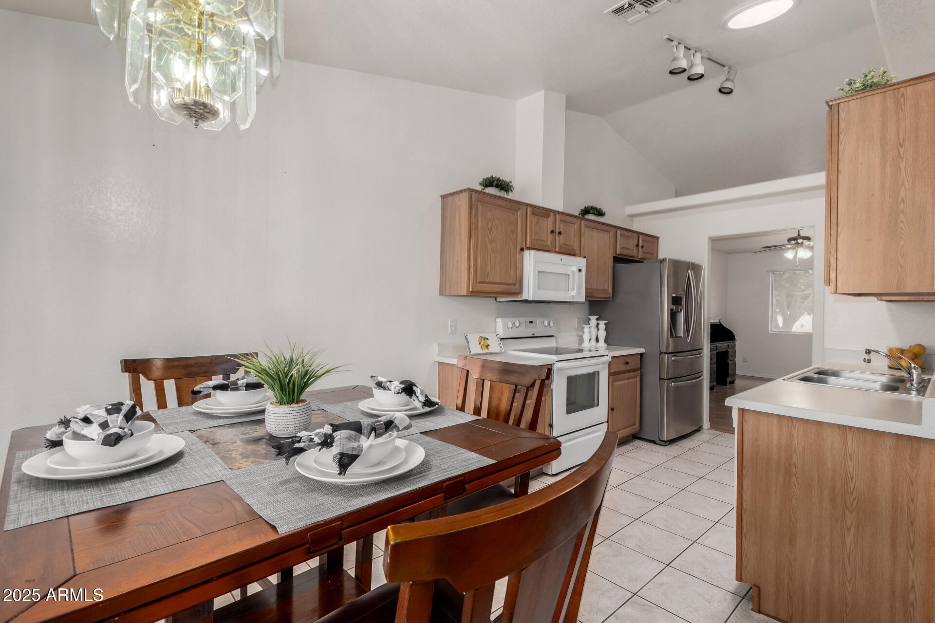 1794 West 11th Avenue Apache Junction, AZ 85120 - Photo 8 of 33 a kitchen with stainless steel appliances kitchen island granite countertop a sink dishwasher stove and microwave oven
