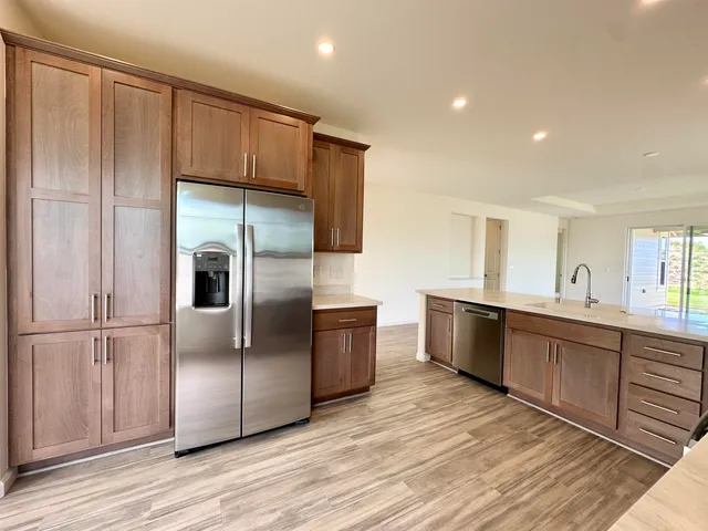 a kitchen with kitchen island granite countertop a sink and cabinets