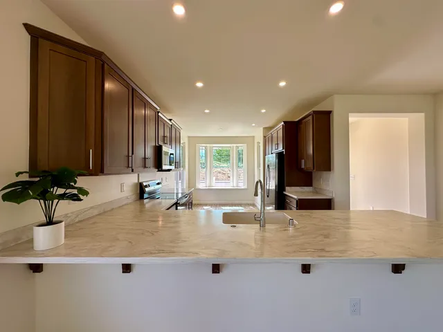 a large kitchen with lots of counter space a sink and dishwasher