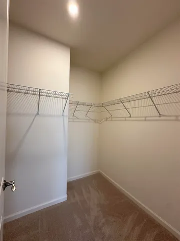 a bathroom with a granite countertop sink a mirror and shower