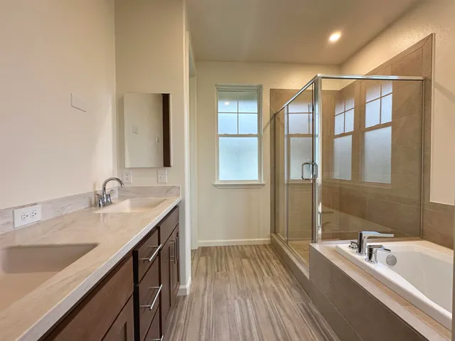 a view of a bathroom with tub and sink
