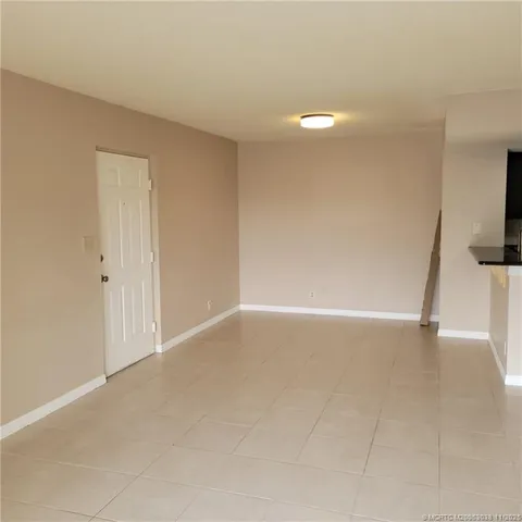 a kitchen with kitchen island granite countertop a sink and a refrigerator