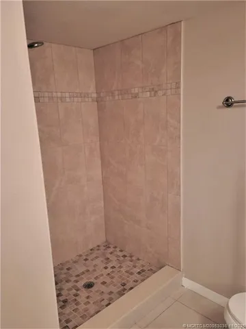 a view of a storage & utility room with refrigerator washer and dryer