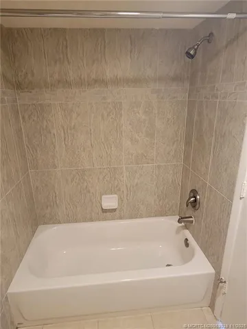 a kitchen with a refrigerator and a sink