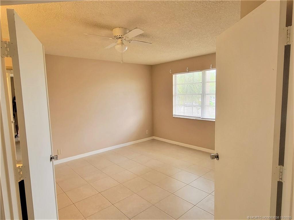 1526 Southeast Royal Green Circle, Unit 205 Port St. Lucie, FL 34952 - Photo 30 of 34 an empty room with windows and fan
