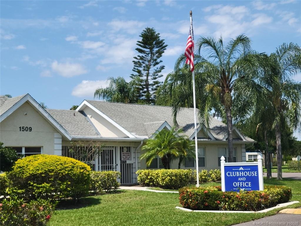 1526 Southeast Royal Green Circle, Unit 205 Port St. Lucie, FL 34952 - Photo 3 of 34 a view of house with a yard and potted plants