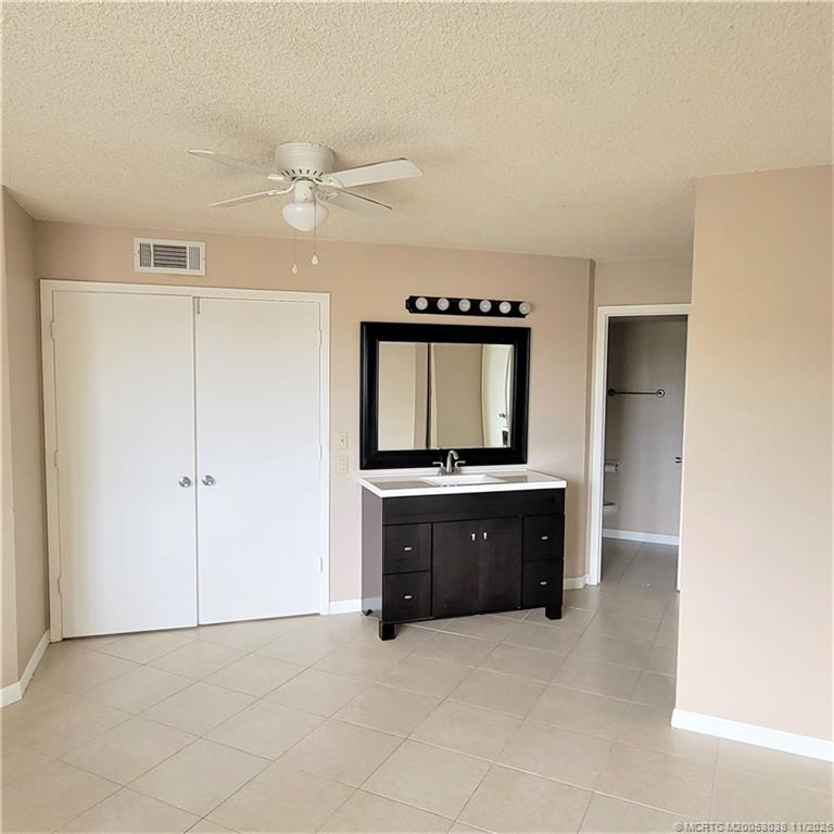 1526 Southeast Royal Green Circle, Unit 205 Port St. Lucie, FL 34952 - Photo 31 of 34 a kitchen with a refrigerator and a sink