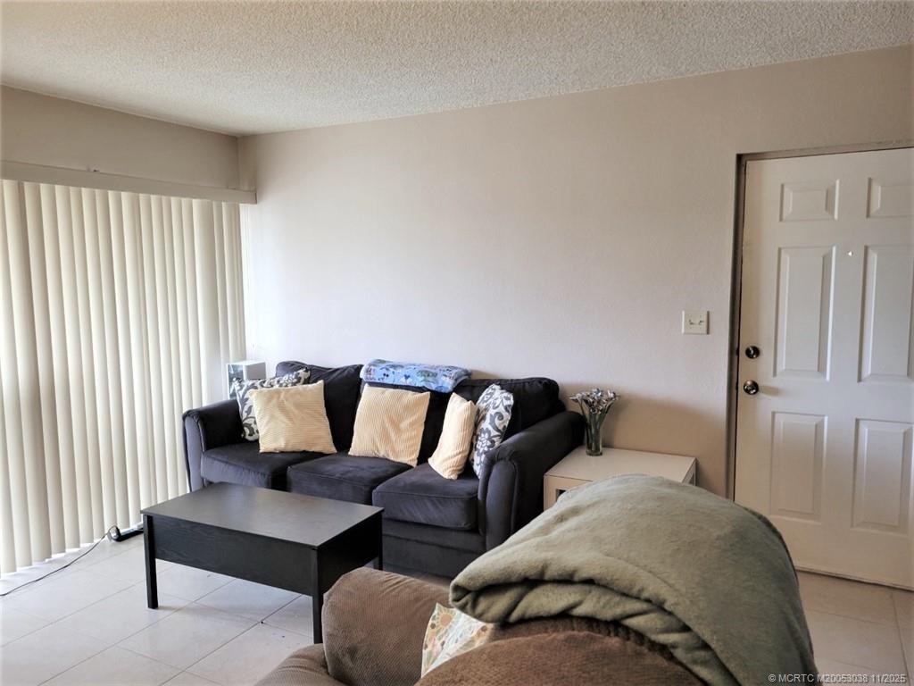 1526 Southeast Royal Green Circle, Unit 205 Port St. Lucie, FL 34952 - Photo 8 of 34 a living room with furniture and a large window