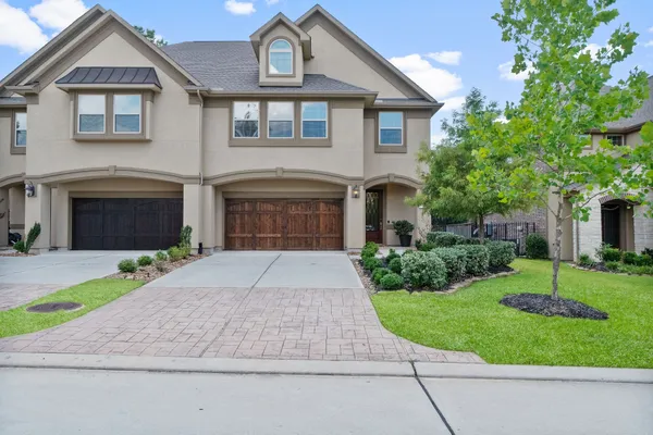 a front view of a house with a yard and a garage