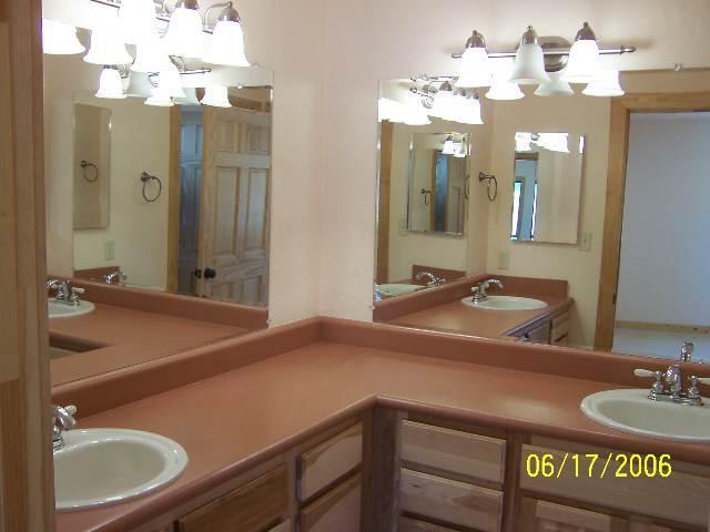 1561 Ovalo Court Rio Rico, AZ 85648 - Photo 6 of 9 a bathroom with a sink and a mirror