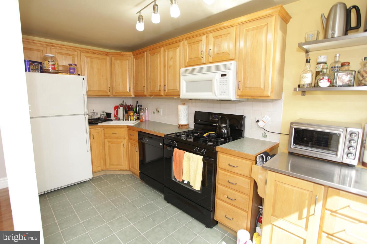 414 Rively Avenue Collingdale, PA 19023 - Photo 11 of 27 a kitchen with stainless steel appliances a stove a sink and a refrigerator
