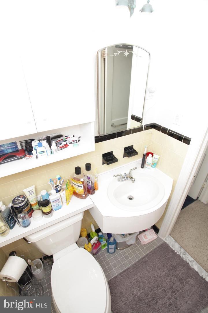 414 Rively Avenue Collingdale, PA 19023 - Photo 19 of 27 a bathroom with a sink toilet and a mirror
