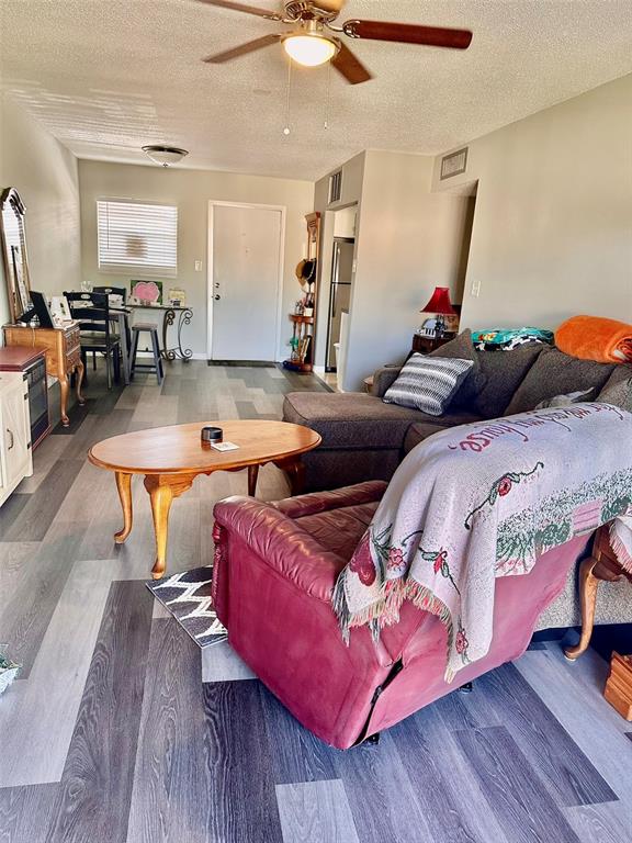 5207 Turquoise Lane, Unit 202 New Port Richey, FL 34652 - Photo 11 of 26 a living room with furniture and wooden floor