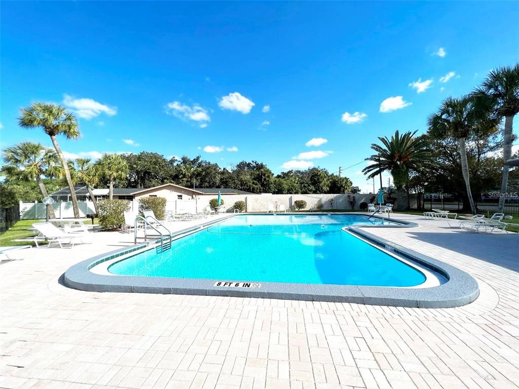 5207 Turquoise Lane, Unit 202 New Port Richey, FL 34652 - Photo 20 of 26 a view of swimming pool with outdoor seating and yard in the back