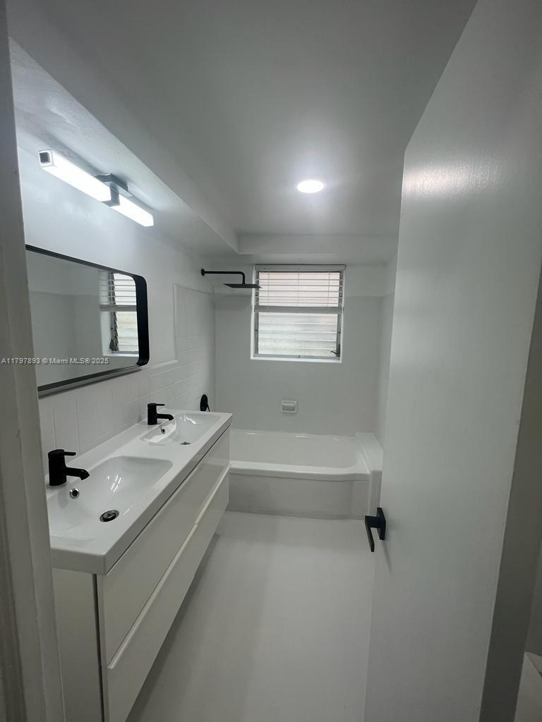 Surfside Surfside, FL 33154 - Photo 6 of 10 a bathroom with a tub sink and mirror