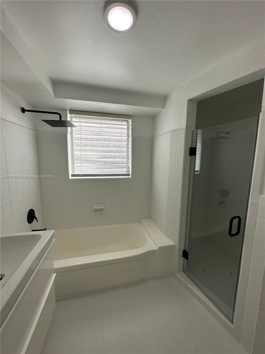 Surfside Surfside, FL 33154 - Photo 9 of 10 a bathroom with a bathtub and a shower