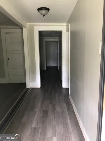 a view of a hallway with wooden floor
