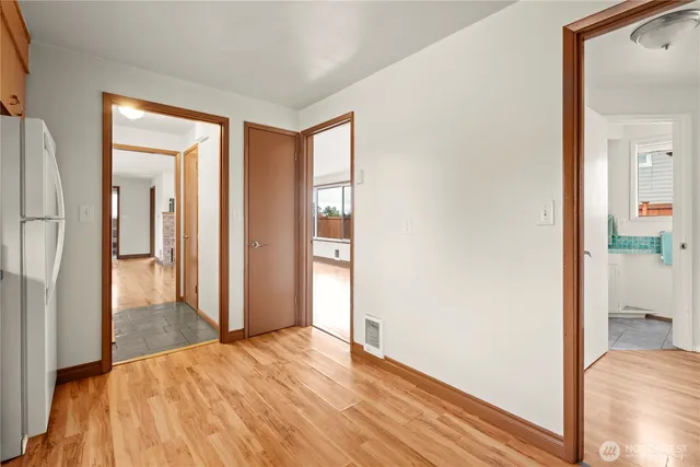 a view of a room with wooden floor and a window