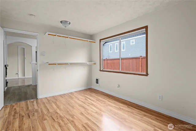 a view of an empty room with a painting on the wall