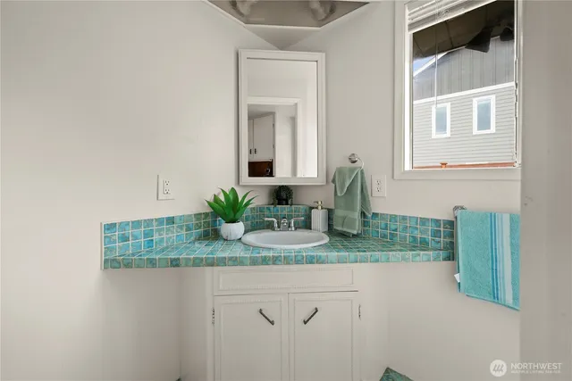 a bathroom with a granite countertop sink a toilet and a mirror