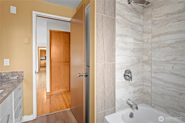 a view of a room with wooden floor and potted plant