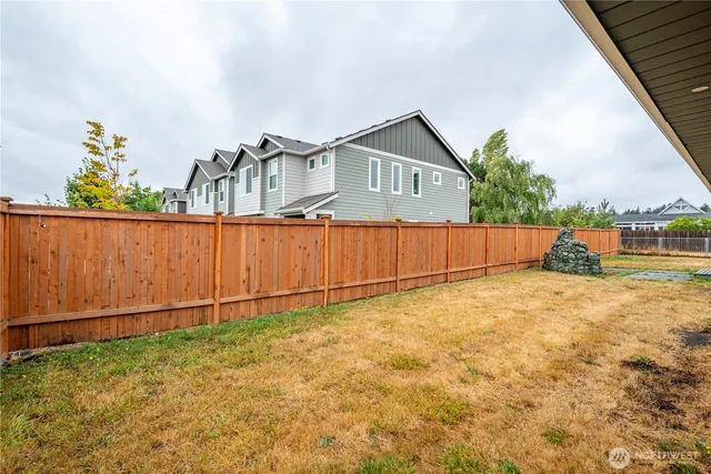 a backyard of a house with table and chairs