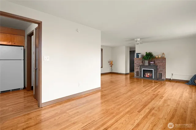 a view of a room with wooden floor and windows
