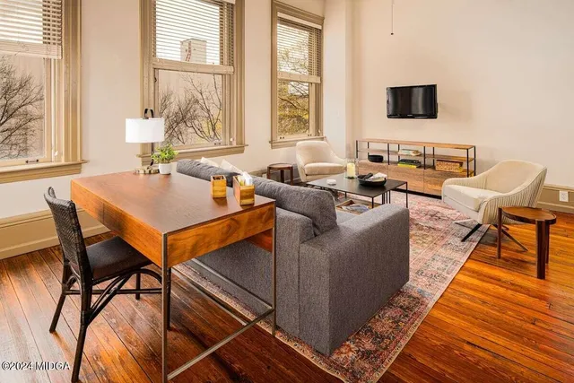 a living room with furniture and a flat screen tv